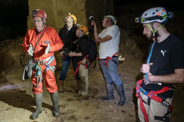 (From left to right) Laurent Dujardin, from the Hérouville speleological team and an archeologist attached to a university laboratory, explains how life in the quarry refuge worked, Jean-Baptiste Rible, INRAP's Grand-Ouest inter-regional director, Noé, 11, son of Cyril and Cyril Marcigny, archeologist at INRAP Normandie and Laboratoire d'Archéologie et Histoire Merlat (Merlat Merlat Archeology and History Laboratory), observe the quarry walls and Marin Madeleine, a speleologist, in the quarry refuge site of the Saingt brewery in Fleury-sur-Orne, France, April 29, 2024?