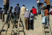 Palestinians on the border wall between the Rafah refugee camp in the southern Gaza Strip and Egypt, September 15, 2005.