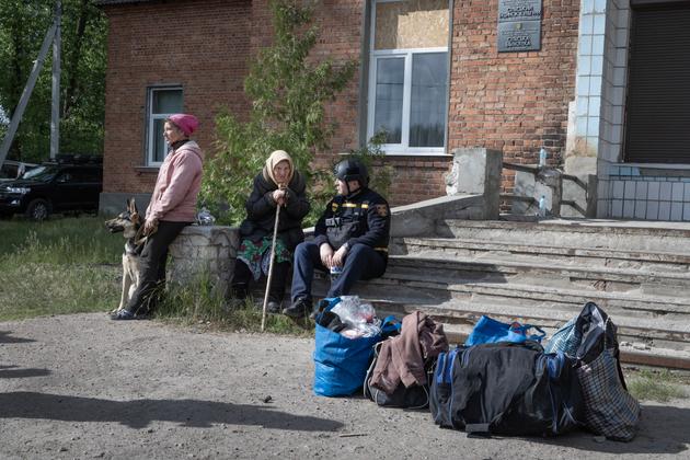 Irina, 47, and her mother Natalia, 85, evacuate the town of Vovchansk, Ukraine, bombed by the Russian army, May 11, 2024.