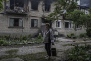 A resident of Vovchansk (Ukraine) in front of her building hit by Russian army shelling, May 11, 2024.
