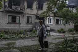 Une habitante de Vovtchansk (Ukraine) devant son immeuble touché par des bombardements de l’armée russe, le 11 mai 2024.