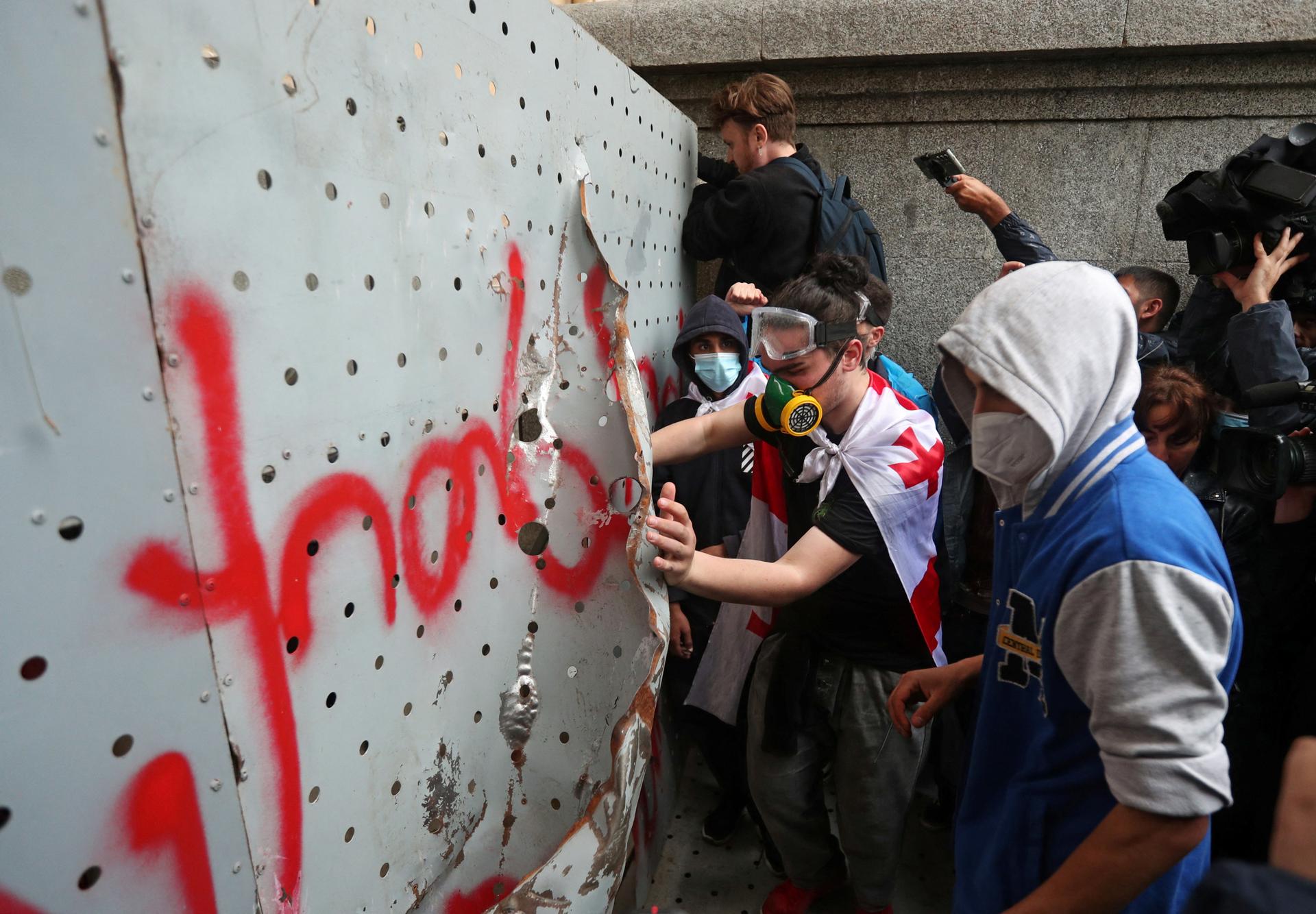 Anti-"foreign influence" law demonstrators, in front of the fence protecting the gates of the Georgian Parliament, Tbilisi, on May 14, 2024.