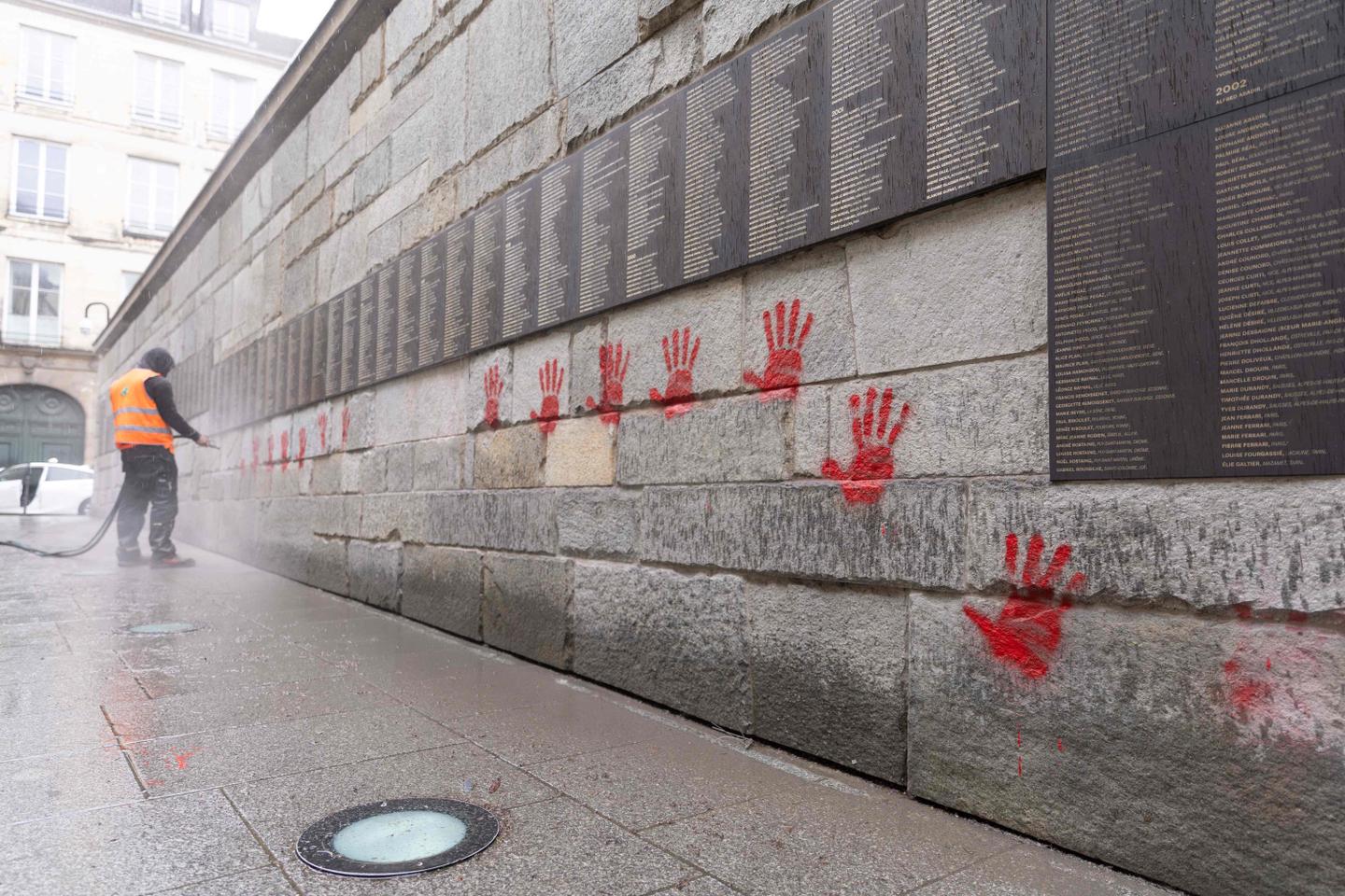 Shoah Memorial in Paris tagged with red hands