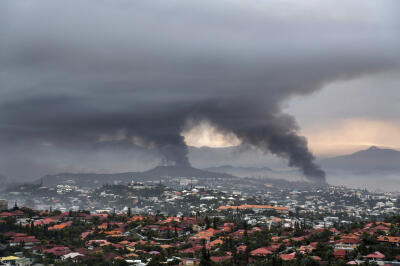 Smoke rises during protests in Noumea, New Caledonia, Wednesday, May 15, 2024.