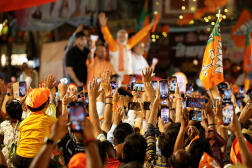Indian Prime Minister Narendra Modi (background) at a campaign event in Varanasi on May 13, 2024.