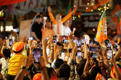 Indian Prime Minister Narendra Modi (background) at a campaign event in Varanasi on May 13, 2024.