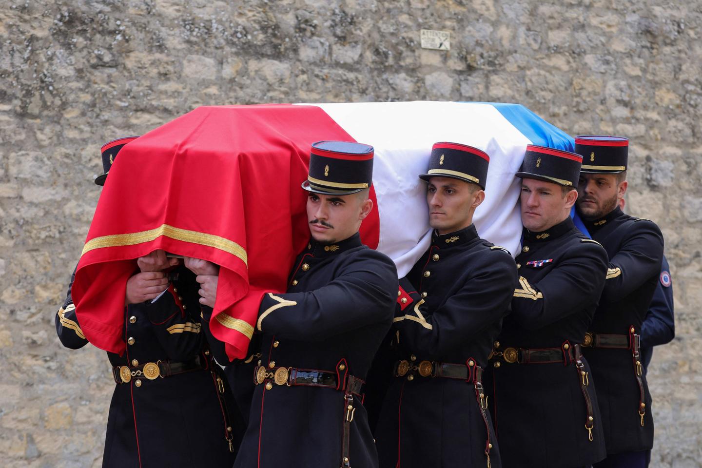 France pays tribute to slain prison officers, with attackers still at large