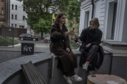 Yelizaveta Koval, 20, and Taissia Krivko, 18, in the courtyard of one of their favorite cafés in Kharkiv, Ukraine, May 15, 2024.
