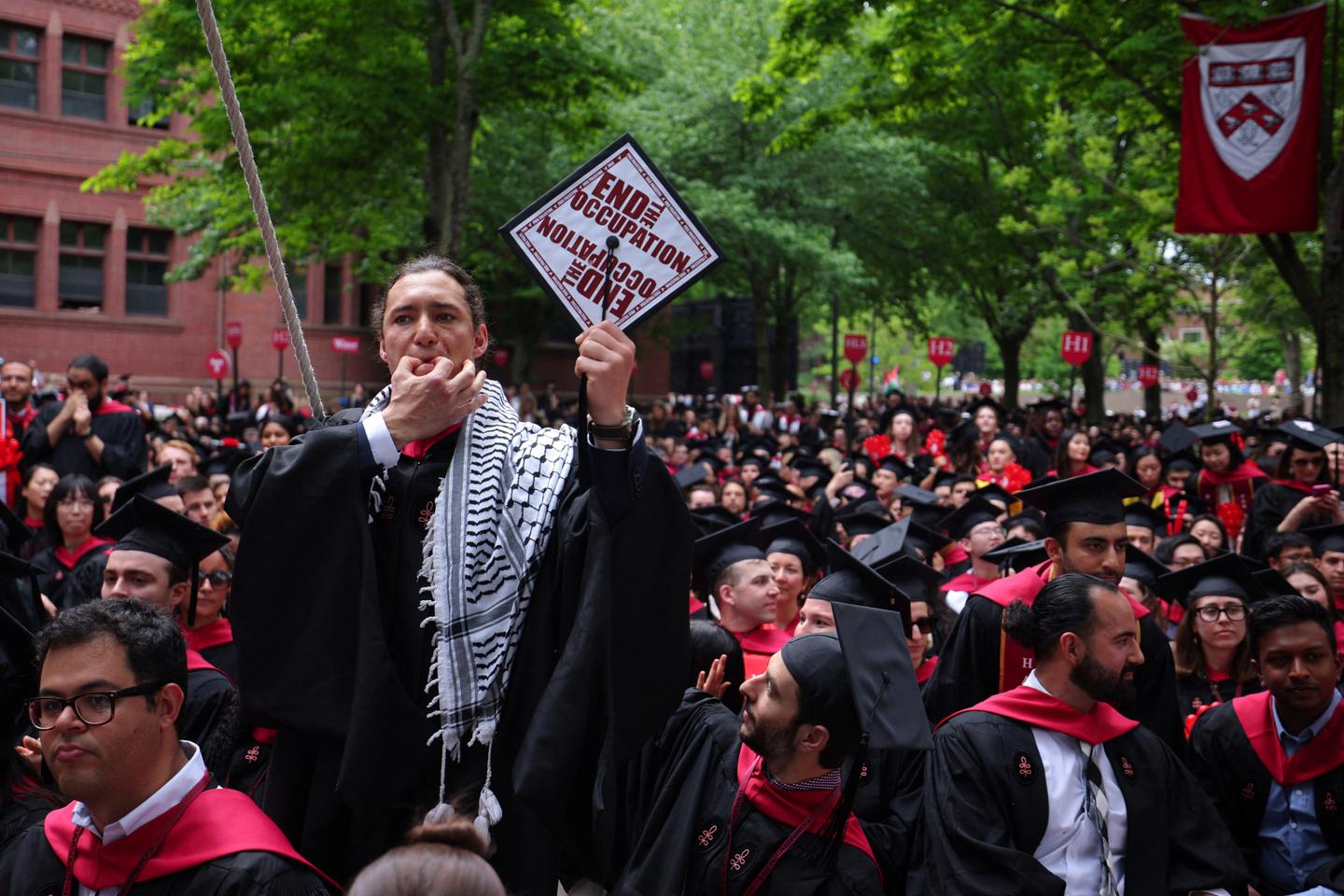 Group of graduates walk out of Harvard commencement chanting 'Free ...