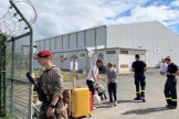 A soldier stands guard as evacuees arrive at the airport in Noumea, New Caledonia, May 25, 2024.