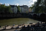 People enjoy sunny and warm weather sitting on the banks of the Seine in Paris on May 11, 2024.