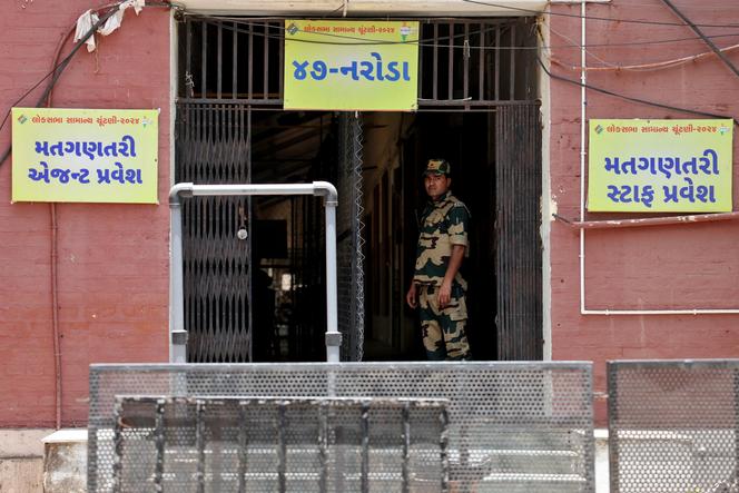 A law enforcement officer in front of a room housing electronic voting machines, in Ahmedabad, India, June 3, 2024.