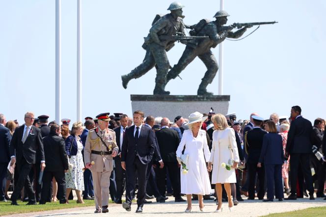Britain's King Charles III walks with French President Emmanuel Macron as Queen Camilla walks with Brigitte Macron at D-Day commemorations in Ver-Sur-Mer, France, June 6, 2024.