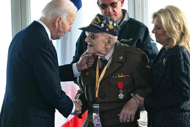 US President Joe Biden speaks with US WWII veteran Robert "Bob" Gibson before the US ceremony at the Normandy American Cemetery and Memorial in Colleville-sur-Mer, which overlooks Omaha Beach in northwestern France, on June 6, 2024. 