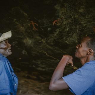 Leparsore Loingeru showing some rock art paintings he claimed he did during his time as a Moran in a cave not far from Ngurunit, Kenya on the 14th of May 2024.