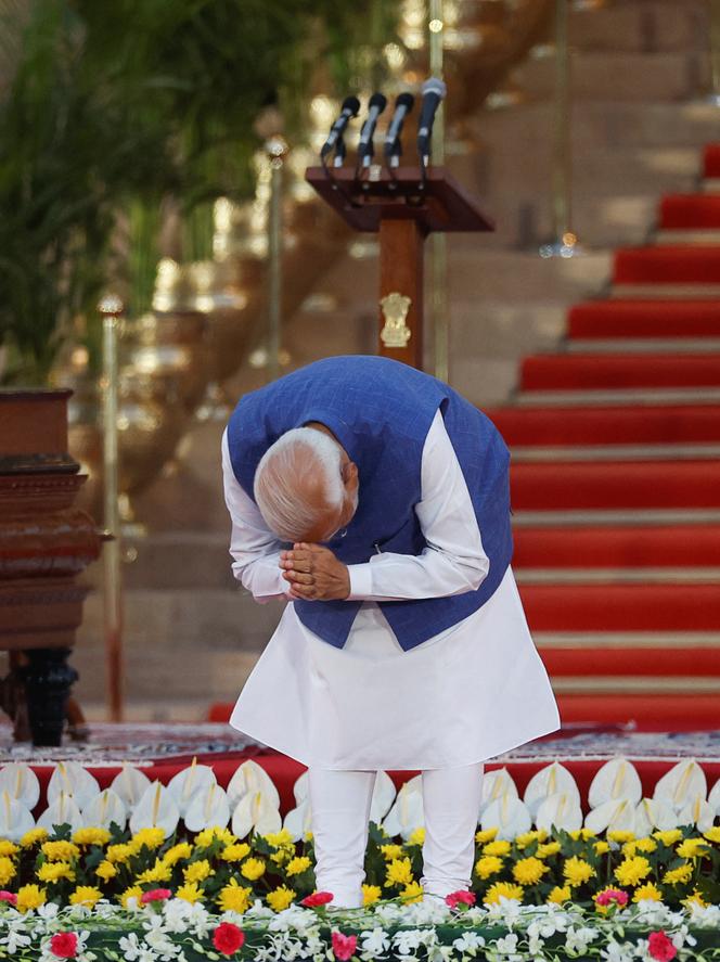 Indian Prime Minister Narendra Modi bows as he is sworn in at the presidential palace in New Delhi on June 9, 2024.