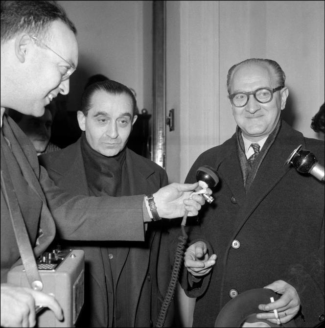 Pierre Mendès France (à gauche), leader du parti radical, et Guy Mollet (à droite), secrétaire général socialiste de la SFIO font une déclaration après s’être réunis lors d’un déjeuner chez Gaston Defferre, le 5 janvier 1956 à Paris, pour discuter des récentes élections législatives gagnées par le Front républicain.