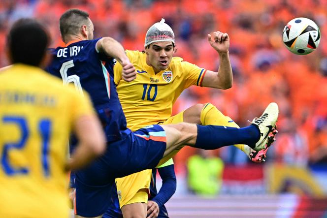 Netherlands beats Romania 3-0 to reach first quarterfinal in 16 years | WN24 1 Romania's midfielder #10 Ianis Hagi and Netherlands' defender #06 Stefan de Vrij fight for the ball during the UEFA Euro 2024 round of 16 football match between Romania and the Netherlands at the Munich Football Arena in Munich on July 2, 2024.
