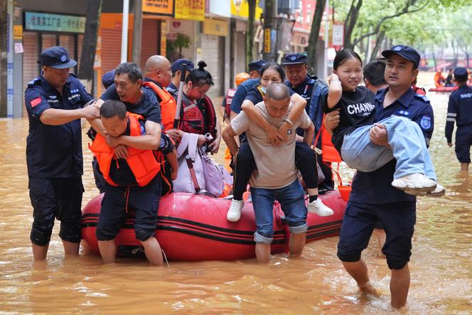 Nearly a quarter of a million people evacuated | WN24 1 Rescue workers evacuate flood-affected residents following heavy rains in Yueyang, in central China's Hunan province on July 2, 2024.