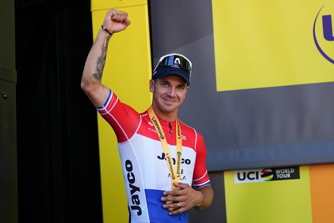 Dutch sprinter Groenewegen wins Stage 6 in a photo finish | WN24 1 Stage winner Netherlands' Dylan Groenewegen celebrates on the podium after the sixth stage of the Tour de France cycling race over 163.5 kilometers with start in Macon and finish in Dijon, France, Thursday, July 4, 2024.