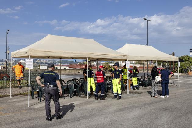 Citizens volunteering for seismic risk drills are welcomed under tents by the Civil Protection Department, in Pozzuoli, June 26, 2024.
