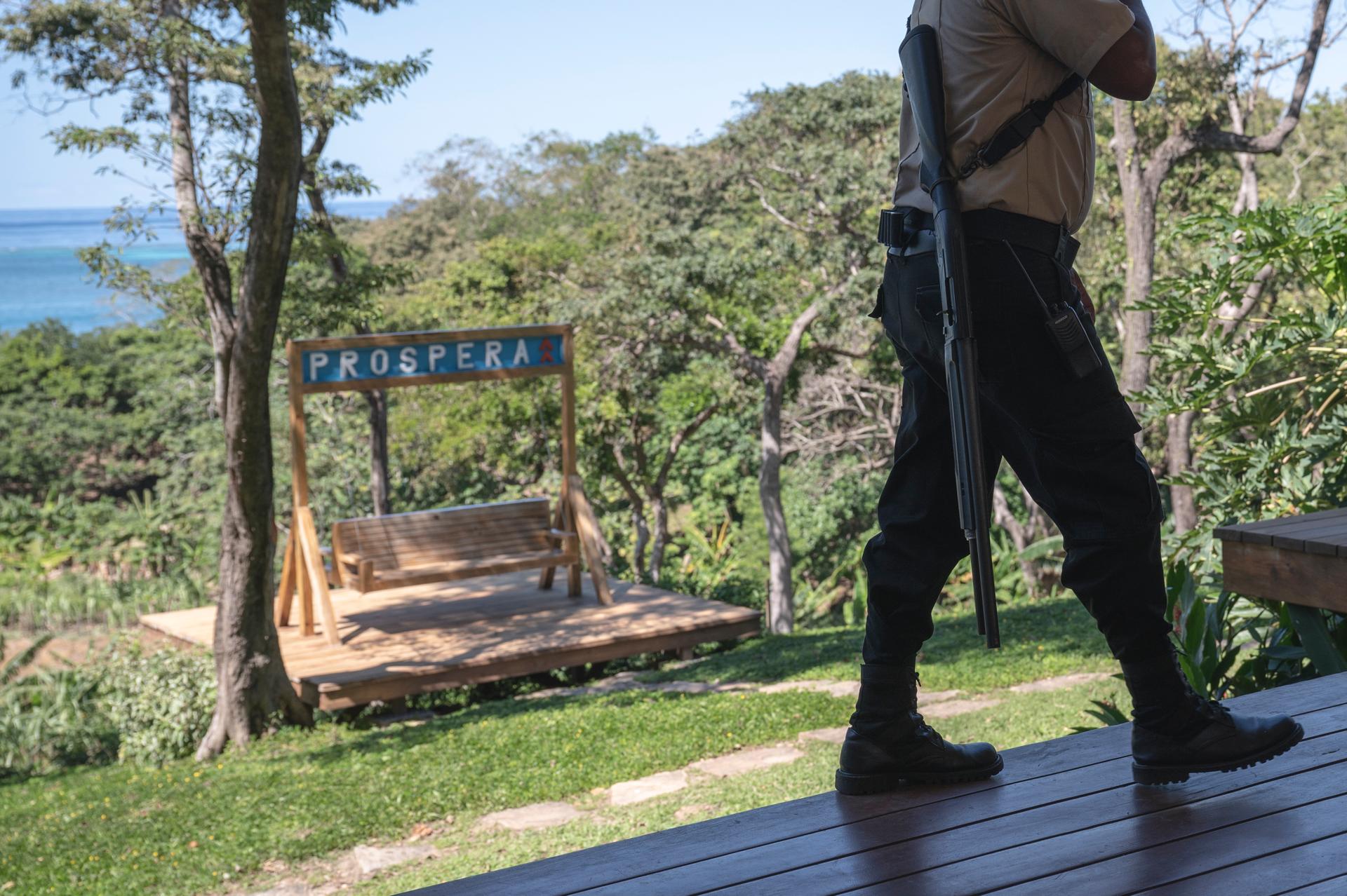 A security guard walking through the buildings at Prospera