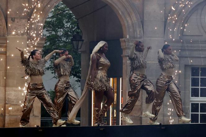 Heavy rain, Céline Dion, hooded torchbearer, diversity... The key moments of a memorable opening ceremony | WN24 1 Aya Nakamura performs during the opening ceremony, backed by musicians of France's Republican Guard, against the backdrop of the Académie Française, on July 26, 2024, in Paris.