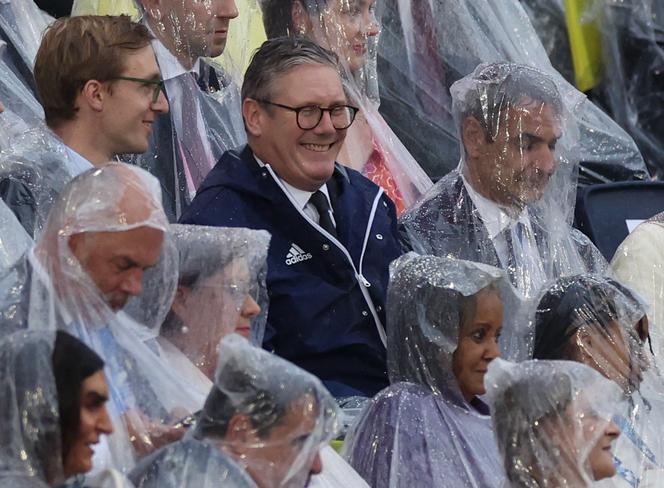 Britain's Prime Minister Keir Starmer is seen wearing a rain coat – but no poncho – during the opening ceremony of the Paris 2024 Olympics, on July 26, 2024.