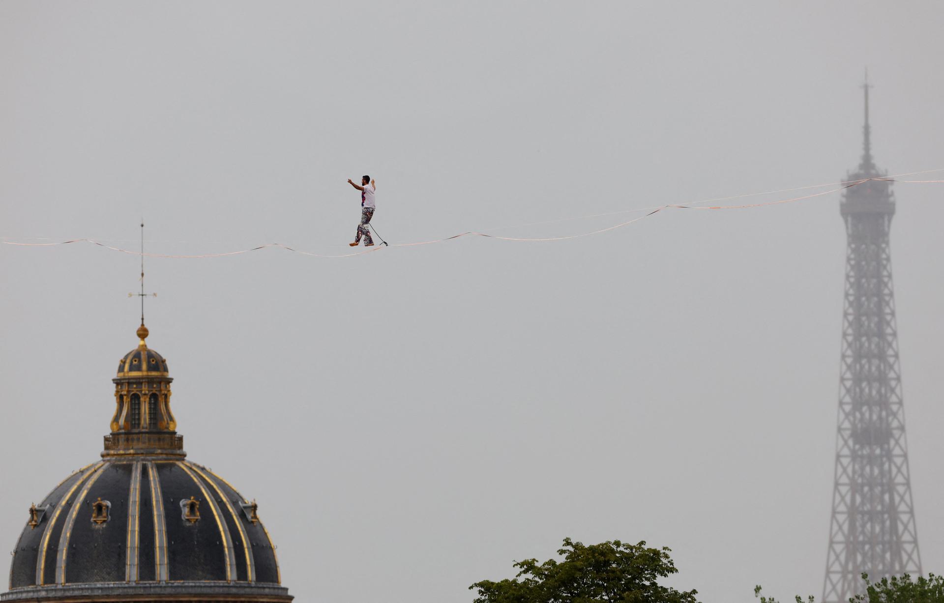 Op 26 juli 2024 slingert een wandelaar over de rivier de Seine, locatie van de openingsceremonie van de Olympische Spelen.