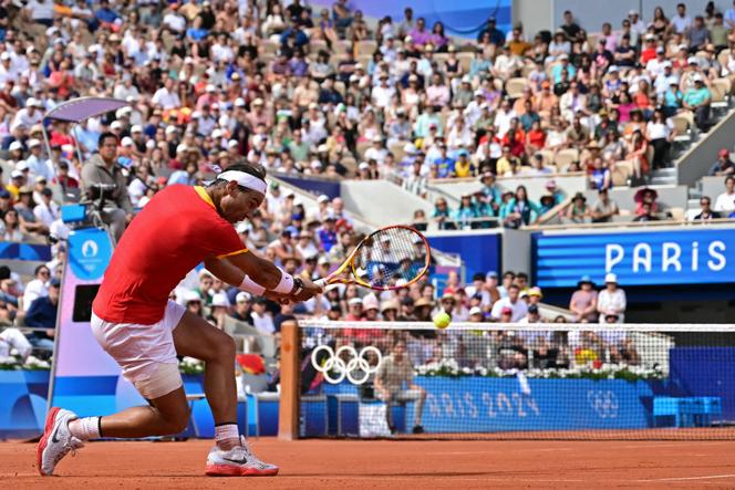 Spain's Rafael Nadal returns to Hungary's Marton Fucsovics during their men's singles first-round tennis match on Court Philippe-Chatrier at the Roland-Garros Stadium at the Paris 2024 Olympic Games on July 28, 2024.