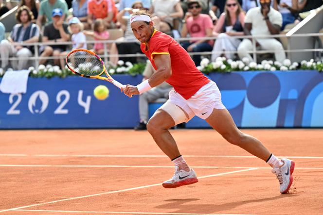 Spain's Rafael Nadal chases the ball while playing Hungary's Marton Fucsovics during their men's singles first-round tennis match on Court Philippe-Chatrier at the Roland-Garros Stadium at the Paris 2024 Olympic Games on July 28, 2024. 