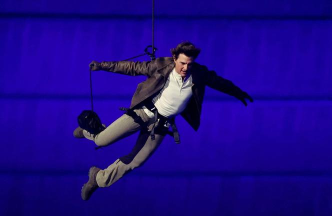 Tom Cruise descends from the sky during the closing ceremony of the Olympic Games at the Stade de France in Saint-Denis (Seine-Saint-Denis) on August 11, 2024.