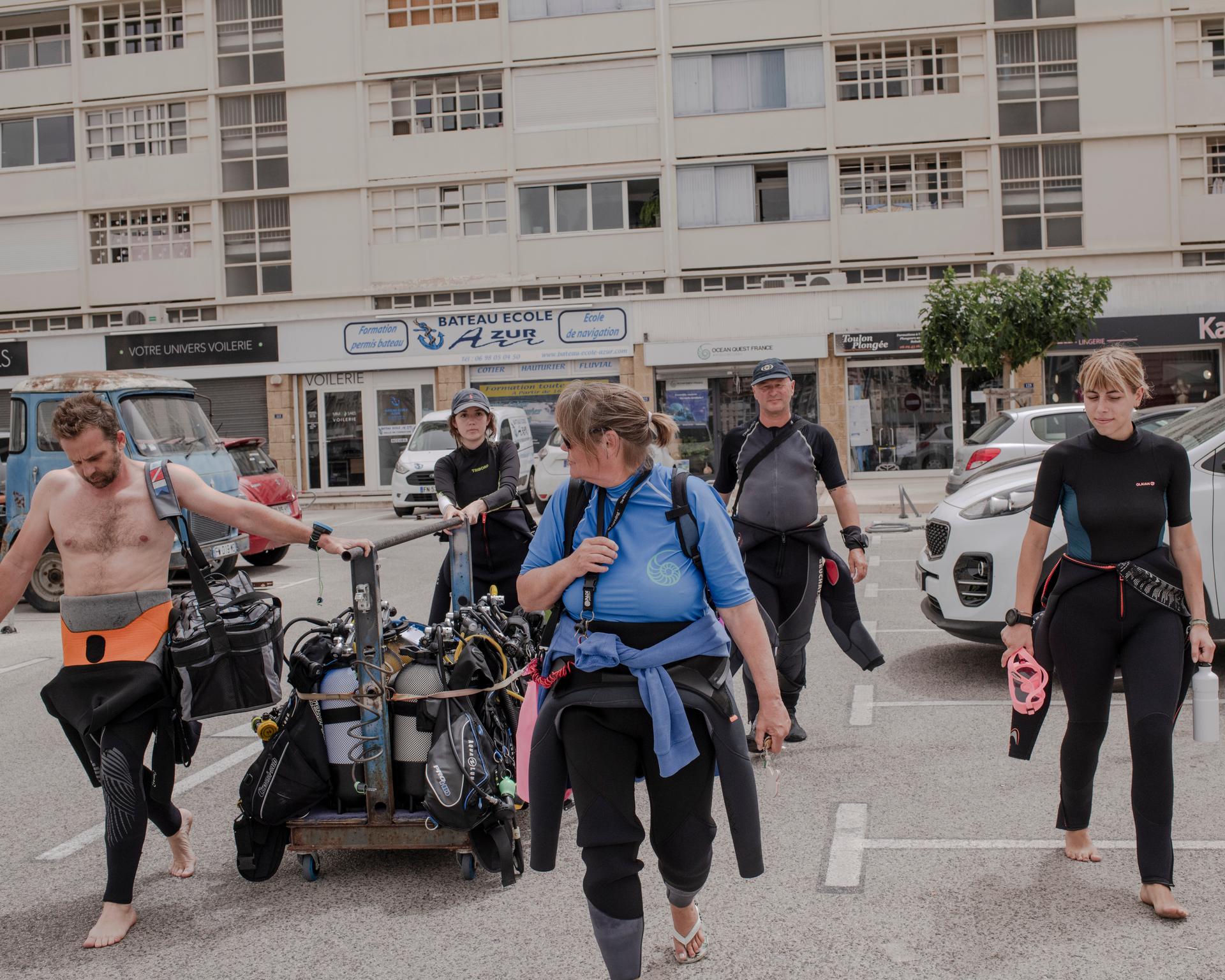 Sandrine Treyvaud, with her team and participants on the 'Coral Gardeners' course, preparing their equipment for the morning dive where they will learn how to measure and catalog coral found underwater. Toulon, June 8, 2024.