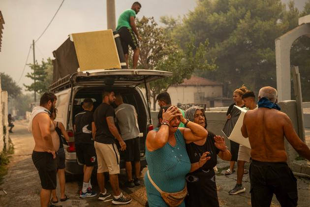 Residents of Pendeli, Greece, flee from the fire approaching their village on August 12, 2024.