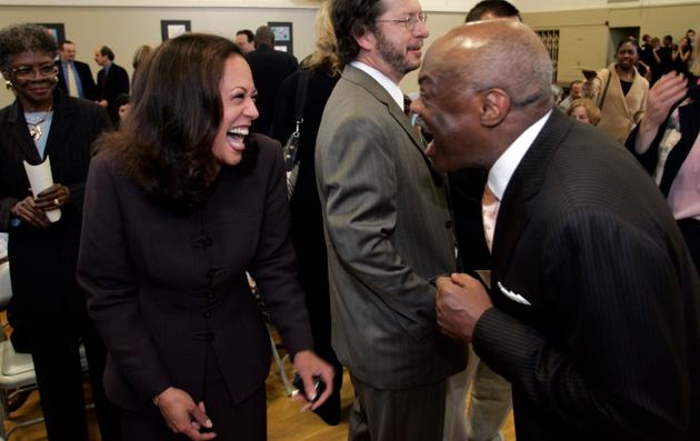 Former mayor Willie Brown, right, laughs with District Attorney Kamala Harris at the reception preceding the dedication ceremony of the Twenty-First Century Academy, in San Francisco on September 27, 2005.