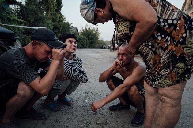 Jenia and Dima, in the village of Tokari, in the Sumy region, on August 25, 2024. Their mother, Lyudmila, was killed by a bomb explosion in her garden.