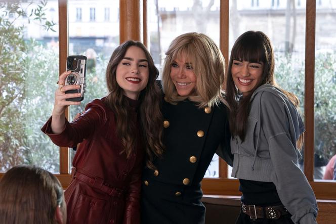 English-American actress and model Lily Collins as Emily (left), French President's wife Brigitte Macron (center) and French actress Thalia Besson as Genevieve during the shooting of episode 407 of the Netflix series