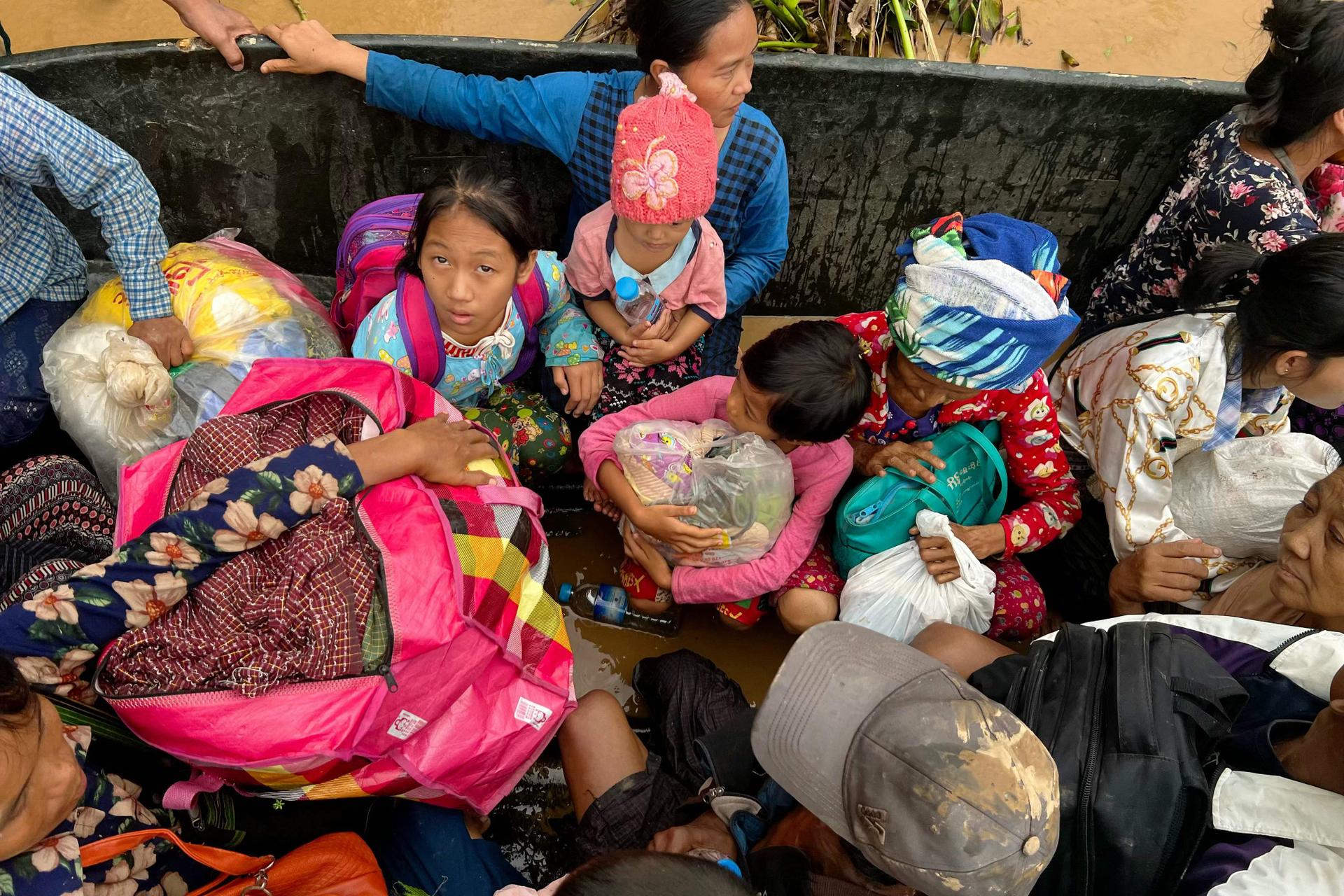 Residents are carried on a boat through floodwaters in Pyinmana, in the Naypyidaw region of Myanmar, on September 13, 2024.