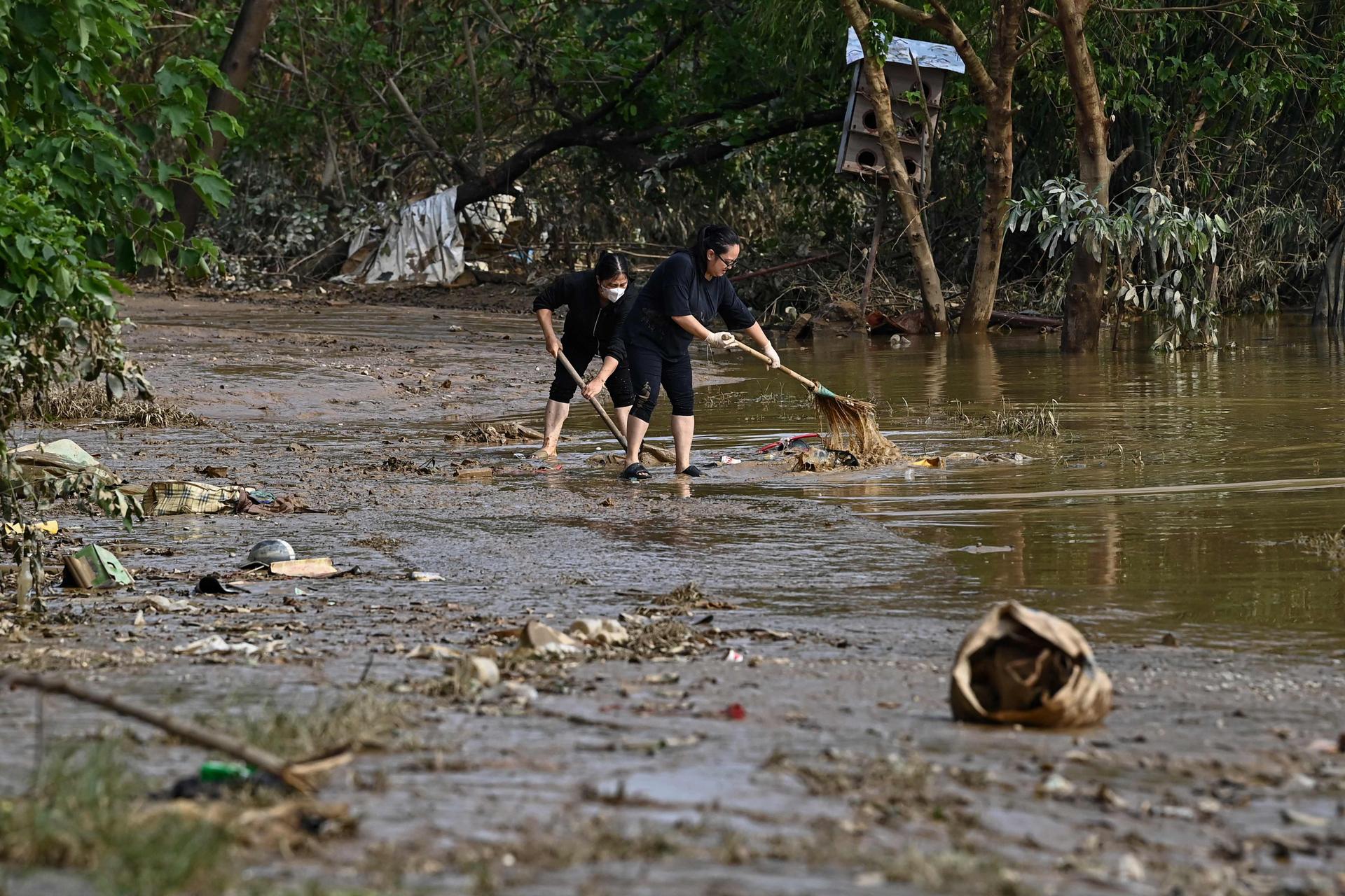 Residents clean up debris after floodwaters receded in Hanoi (Vietnam), September 13, 2024.