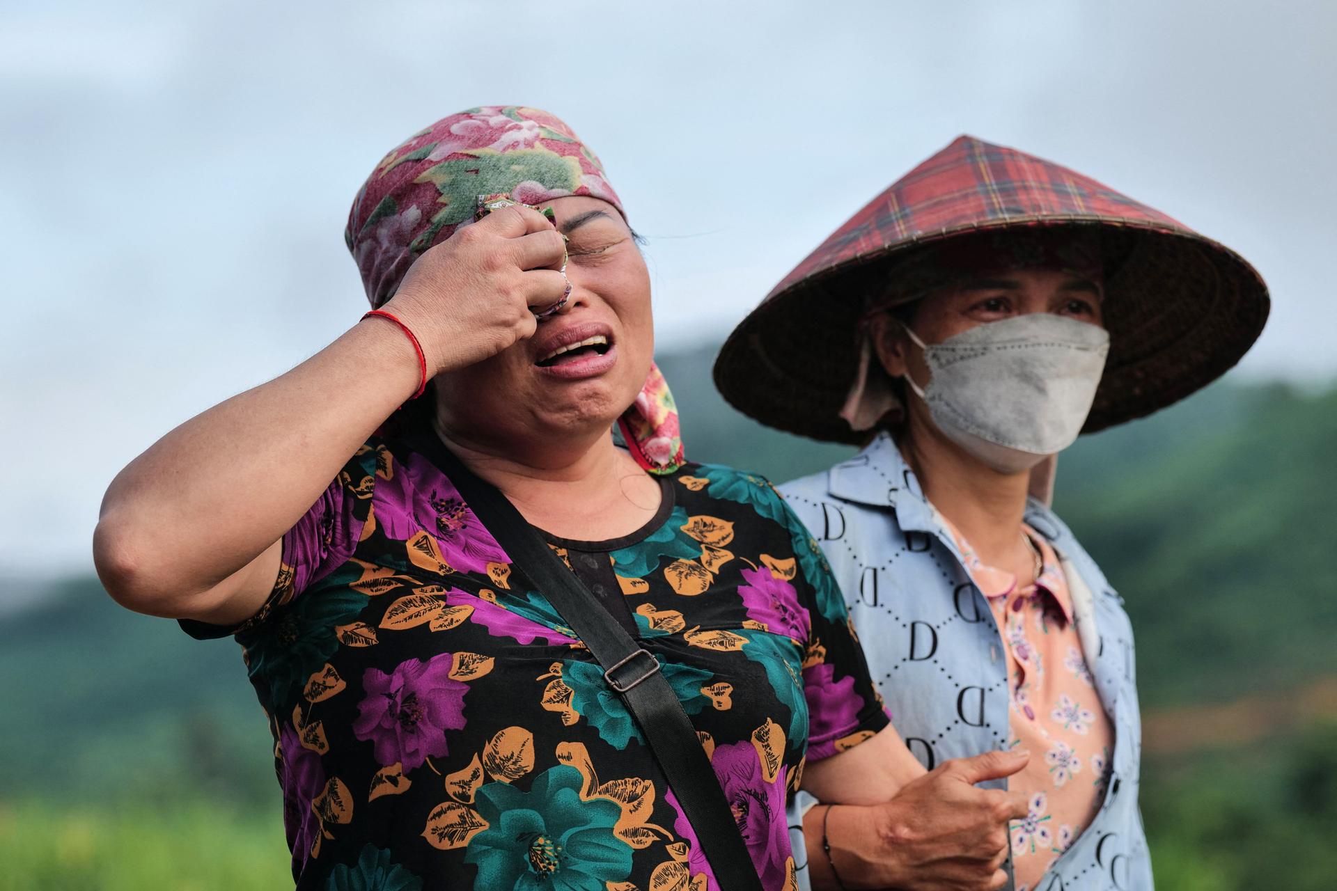 Residents at the site of a landslide in the remote mountain village of Lang Nu, Lao Cai province, Vietnam, September 12, 2024.
