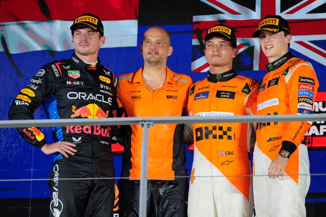 Max Verstappen (à esquerda) e os dois pilotos da McLaren, Lando Norris e Oscar Piastri (à direita), no pódio em Cingapura, 22 de setembro de 2024.