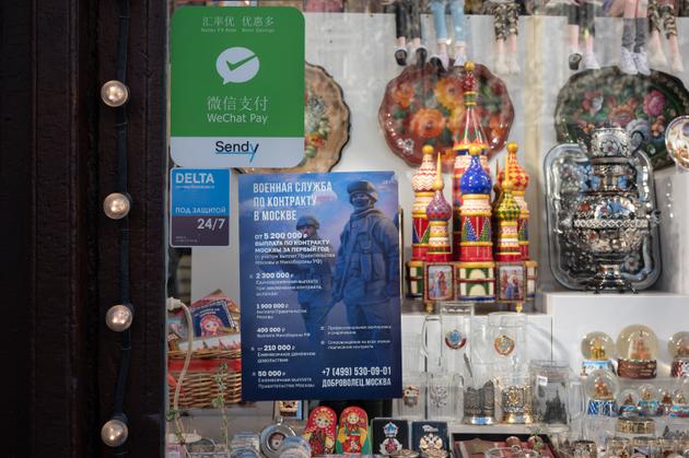Posters in store windows show the financial benefits of joining the Russian army, Moscow, September 22, 2024.