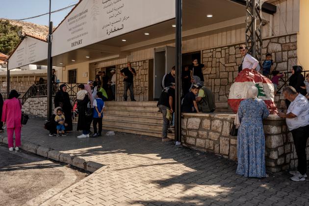 On the Lebanese side of the Masnaa border crossing, people wait for their papers to leave for Syria on September 27, 2024.