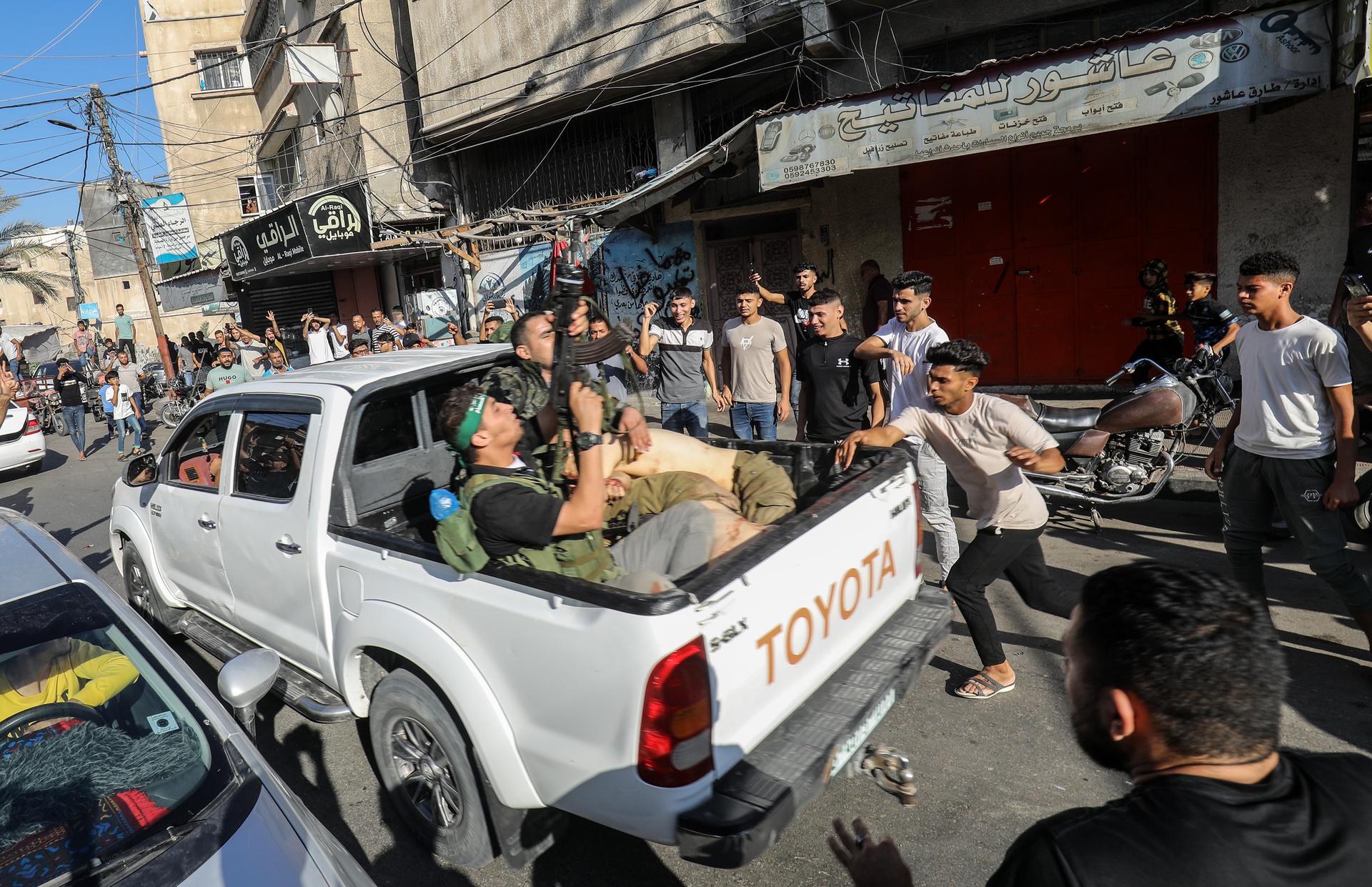 A truck returning from Israel with what appears to be an Israeli prisoner on board, in Khan Yunis, October 7, 2023.