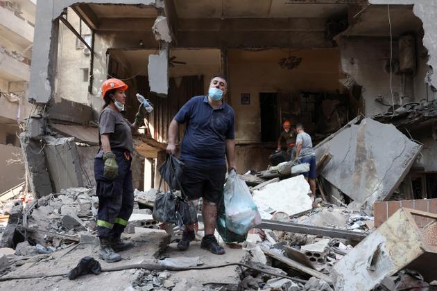 In the aftermath of the strike, people inspect the damage at the site of an Israeli strike, in Beirut, Lebanon, October 11, 2024.