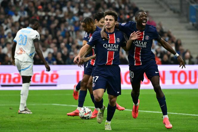 O meio-campista português do Paris Saint-Germain, João Neves (centro), comemora o gol inaugural na vitória sobre o OM na Ligue 1 (3-0), domingo, 27 de outubro, no Stade-Vélodrome, em Marselha.