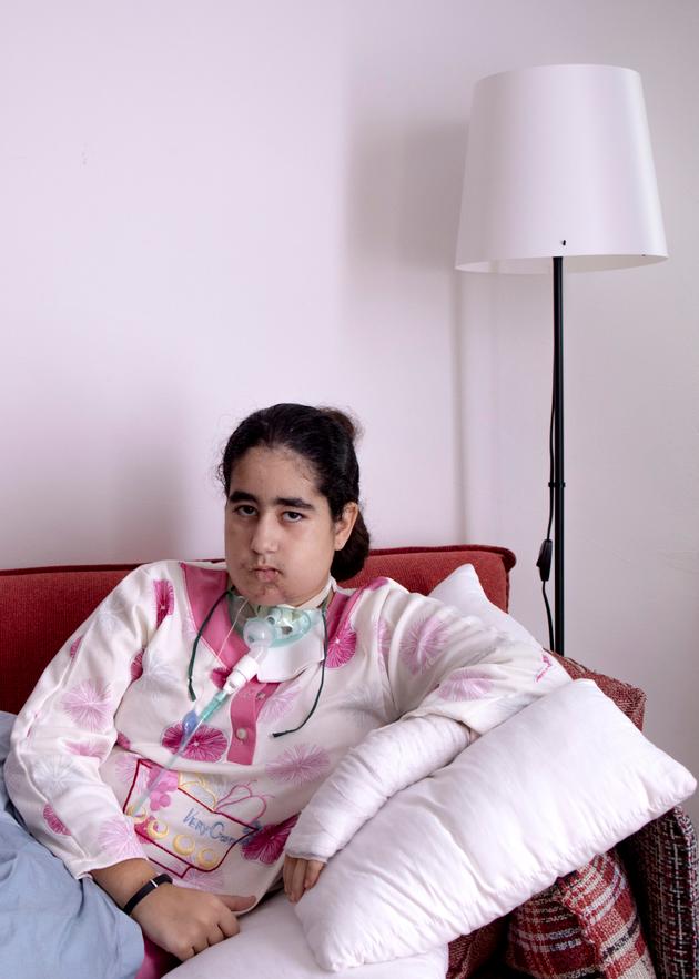 Zahra, seriously wounded in the throat and arm during an Israeli bombardment in Nabatieh in September, is laid up in an apartment in Beirut on October 17, 2024.
