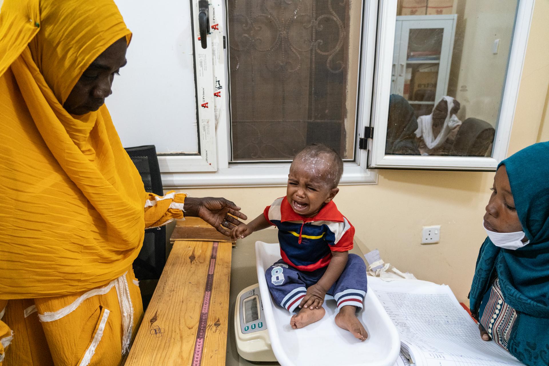 Pediatrician Fatima Haroun, 27, during a consultation with a malnourished child at Al-Shuhada hospital, north of Khartoum, October 27, 2024.