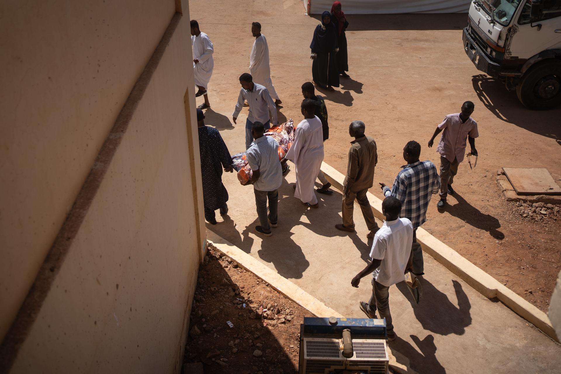 People carry a body out of Al-Naw Hospital, Omdurman, Sudan, October 26, 2024.