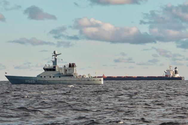 The Chinese bulk carrier "Yi-Peng 3" (background) at anchor, watched by a Danish navy vessel, in the middle of the Cattegat Strait, November 20, 2024.